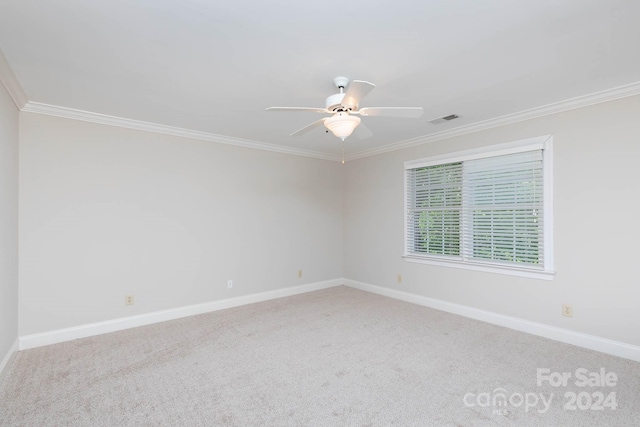 carpeted empty room featuring ceiling fan and ornamental molding