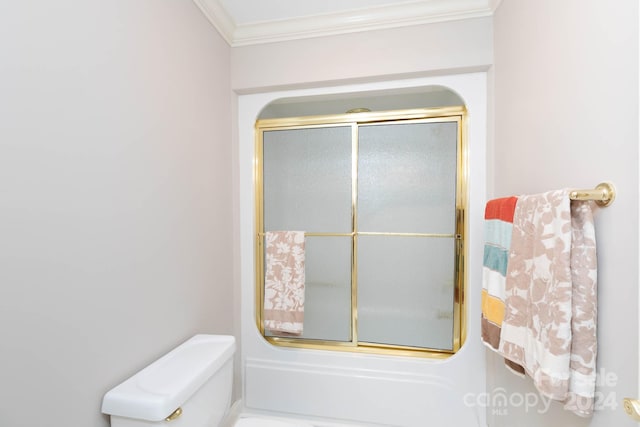 bathroom featuring crown molding, combined bath / shower with glass door, and toilet