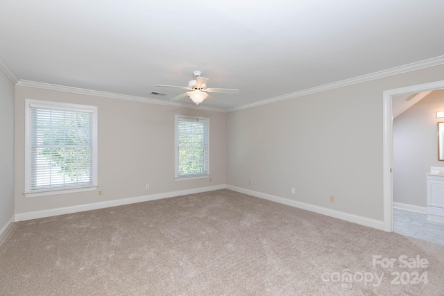 carpeted empty room featuring ceiling fan and ornamental molding