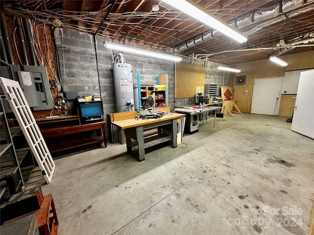 basement with a workshop area, electric panel, and water heater