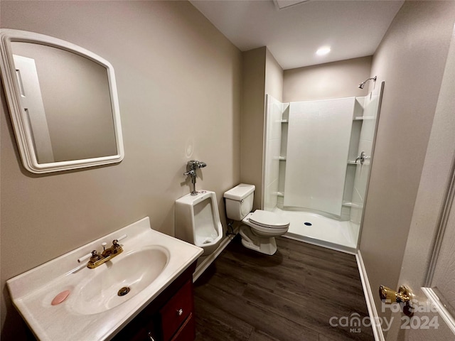 bathroom featuring vanity, toilet, wood-type flooring, and walk in shower