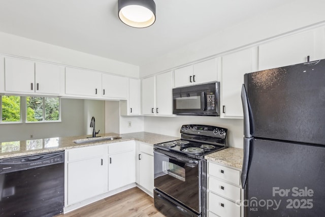 9424 Lexington Cir Unit F, Charlotte, NC 28213 - kitchen with black appliances, a sink, light wood-style flooring, and white cabinets