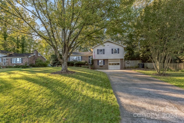 split level home featuring a front yard and a garage