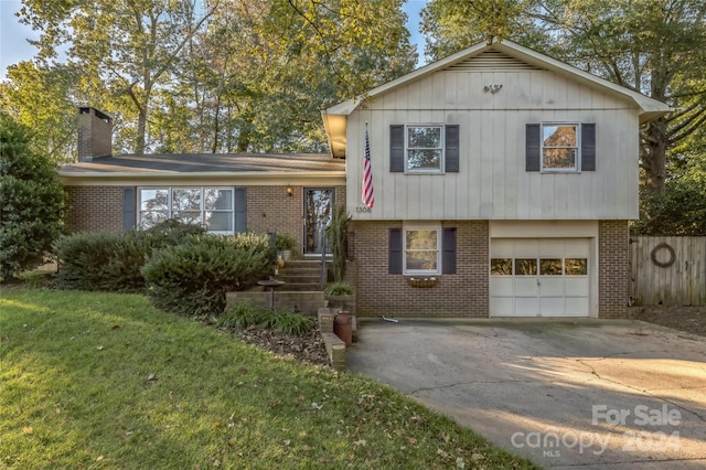 tri-level home with a front lawn and a garage