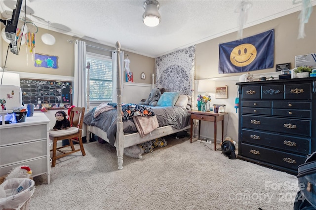 carpeted bedroom with ornamental molding and a textured ceiling