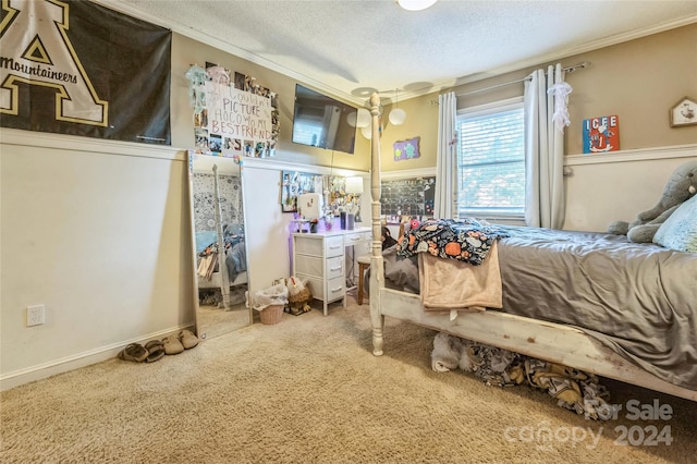 bedroom with ornamental molding, carpet, and a textured ceiling