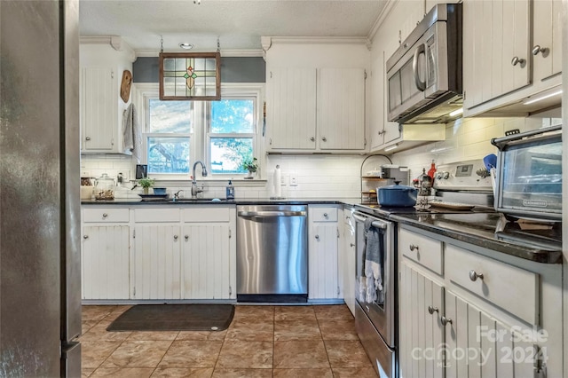 kitchen featuring ornamental molding, sink, white cabinets, and stainless steel appliances