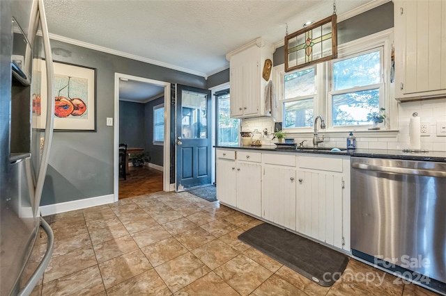 kitchen featuring white cabinets, stainless steel appliances, sink, and backsplash