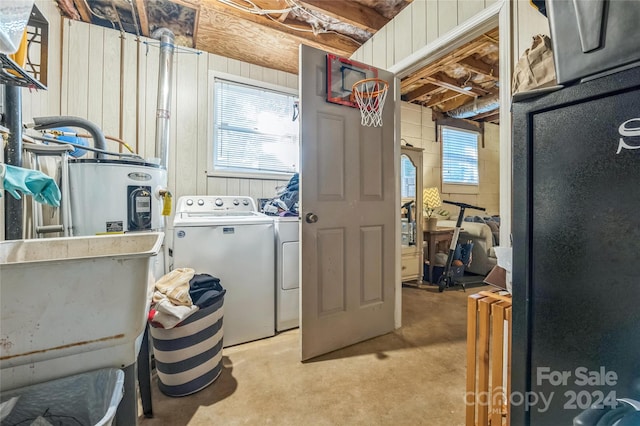 laundry room featuring water heater and separate washer and dryer