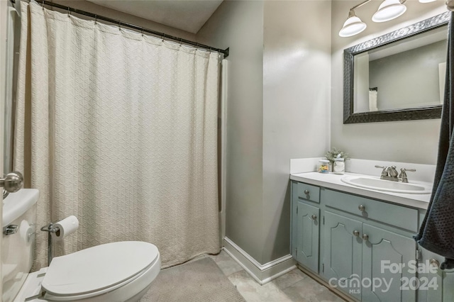 bathroom with vanity, toilet, tile patterned floors, and curtained shower