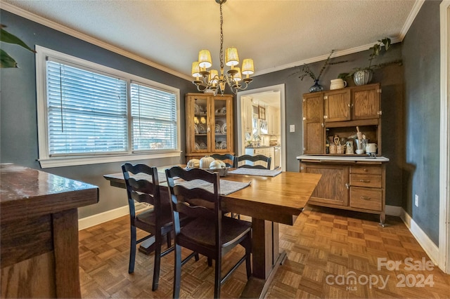 dining space with crown molding, dark parquet flooring, and a chandelier