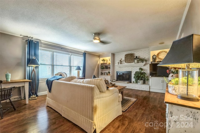 living room with dark wood-type flooring, a brick fireplace, crown molding, and a textured ceiling