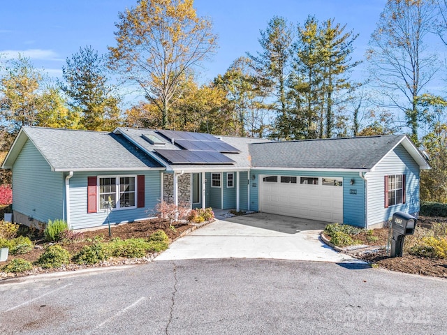 single story home with a garage and solar panels