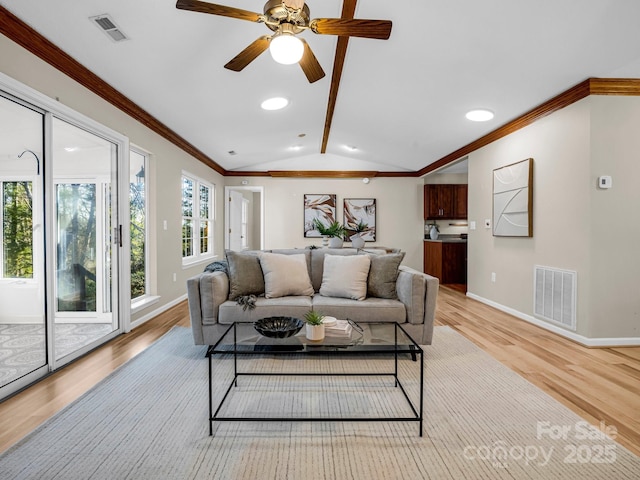 living room featuring crown molding, ceiling fan, light hardwood / wood-style floors, and vaulted ceiling