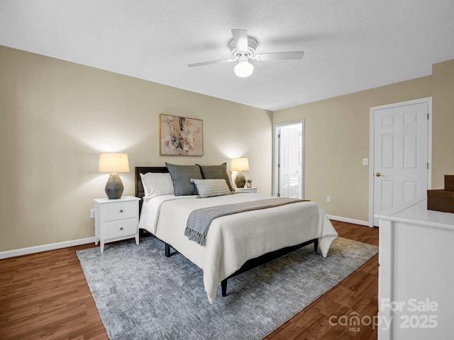 bedroom featuring hardwood / wood-style flooring, a textured ceiling, and ceiling fan