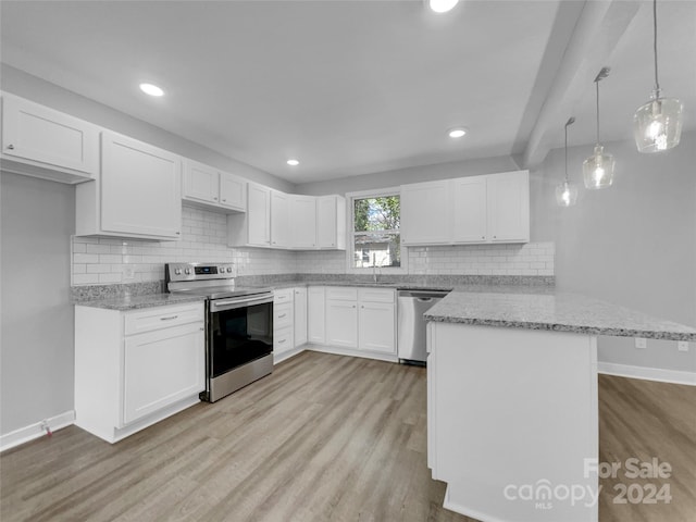 kitchen with kitchen peninsula, white cabinets, pendant lighting, appliances with stainless steel finishes, and light hardwood / wood-style floors