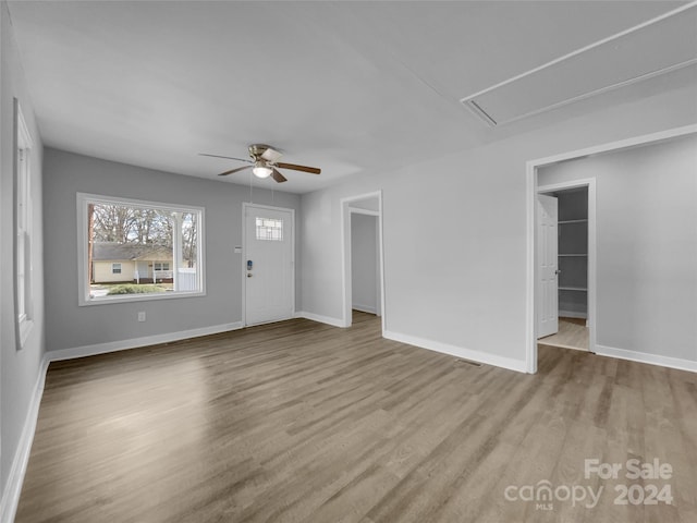 unfurnished living room featuring light wood-type flooring and ceiling fan