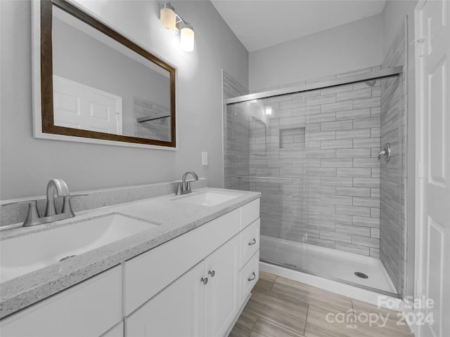 bathroom featuring vanity and a shower with shower door