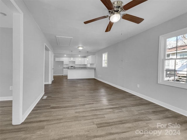 unfurnished living room with wood-type flooring and ceiling fan