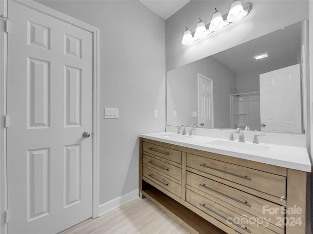 bathroom featuring vanity, hardwood / wood-style floors, and walk in shower