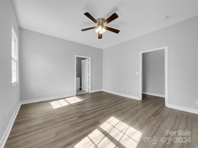 empty room with hardwood / wood-style floors and ceiling fan