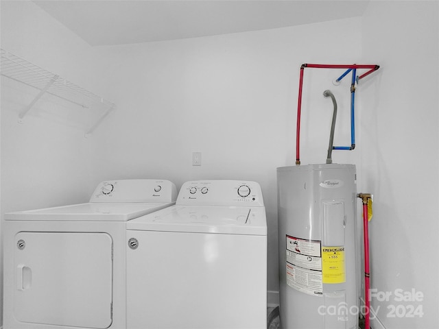 laundry area featuring water heater and washer and dryer