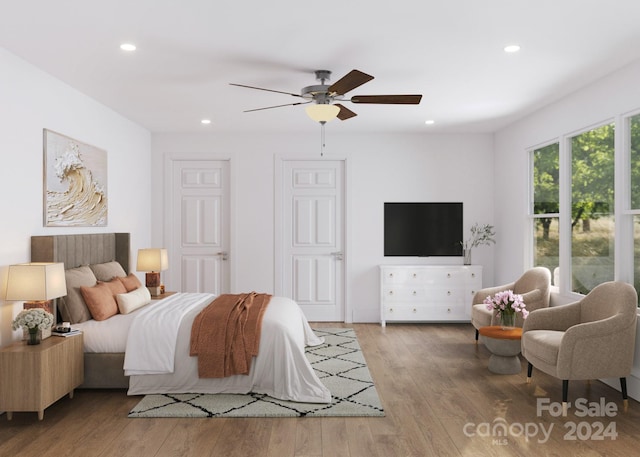 bedroom with ceiling fan and wood-type flooring