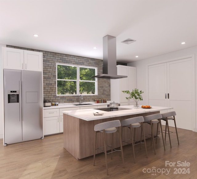 kitchen featuring white cabinets, light hardwood / wood-style flooring, refrigerator with ice dispenser, ventilation hood, and a kitchen island