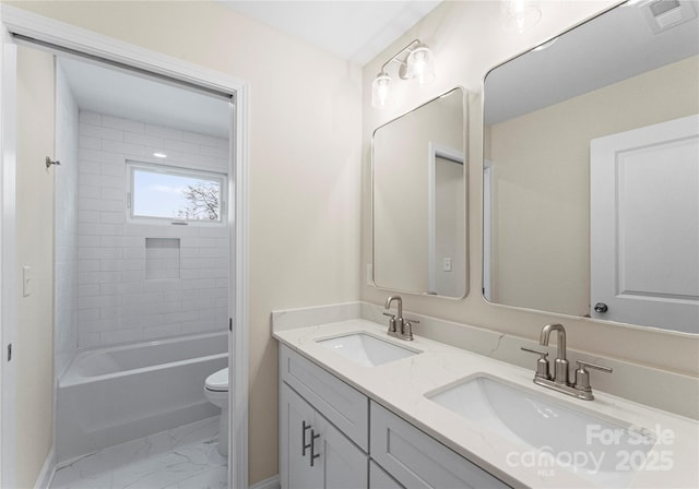 full bathroom with visible vents, marble finish floor, a sink, and toilet