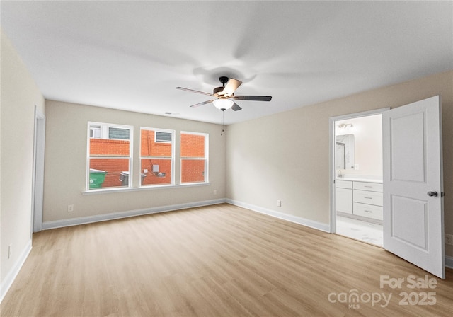 spare room featuring ceiling fan, visible vents, light wood-style flooring, and baseboards