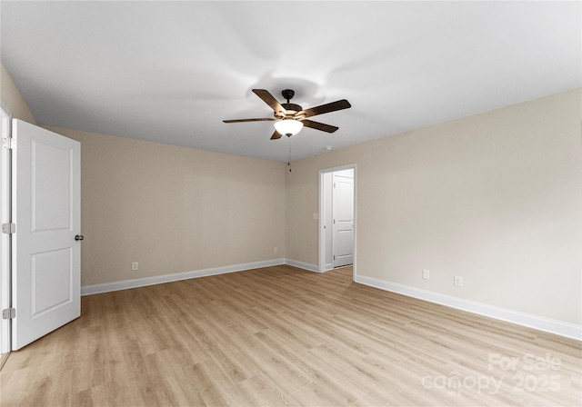 unfurnished room with light wood-style floors, baseboards, and a ceiling fan