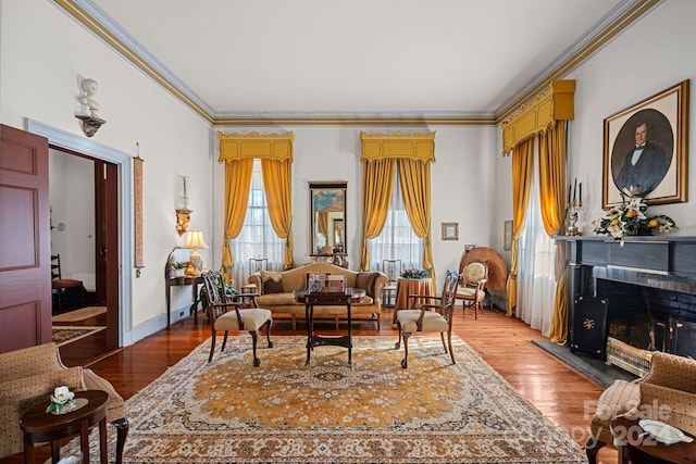 sitting room featuring wood-type flooring and crown molding