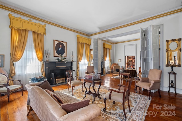 living room featuring hardwood / wood-style flooring and ornamental molding