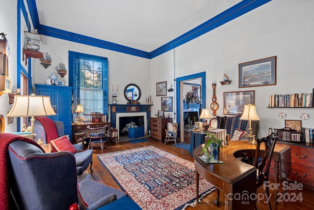 living room featuring dark hardwood / wood-style floors and ornamental molding