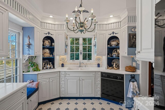 kitchen featuring a chandelier, dishwasher, ornamental molding, and sink