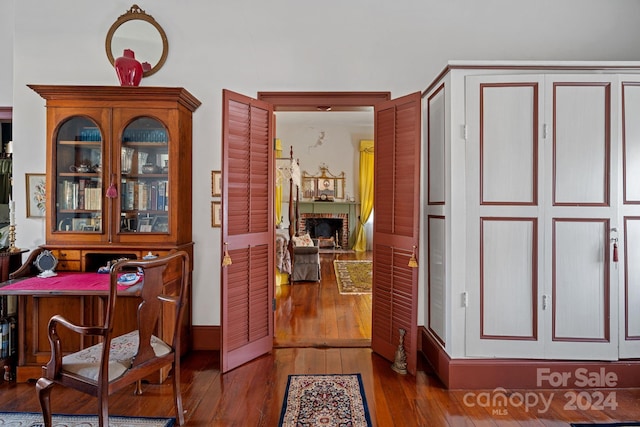 interior space with a fireplace and dark hardwood / wood-style flooring