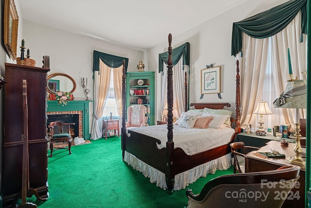 bedroom featuring carpet flooring and a fireplace