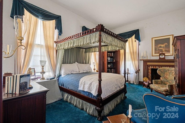 carpeted bedroom featuring a fireplace and vaulted ceiling