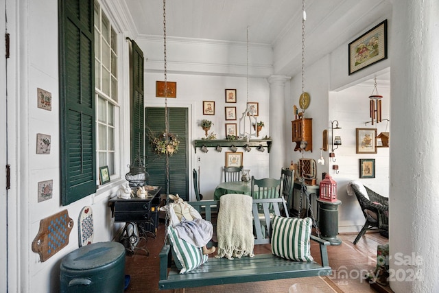 living room featuring wood-type flooring, decorative columns, and ornamental molding