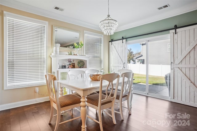 dining room with ornamental molding, a barn door, an inviting chandelier, and dark wood-type flooring