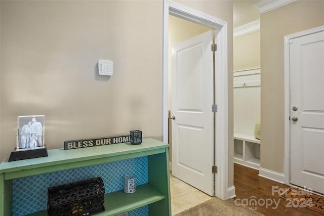 interior space with hardwood / wood-style floors and crown molding