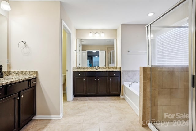 full bathroom with tile patterned flooring, vanity, toilet, and independent shower and bath