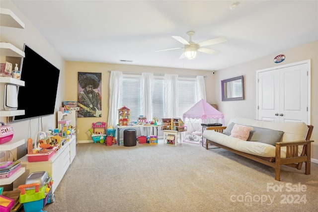 game room featuring light colored carpet and ceiling fan