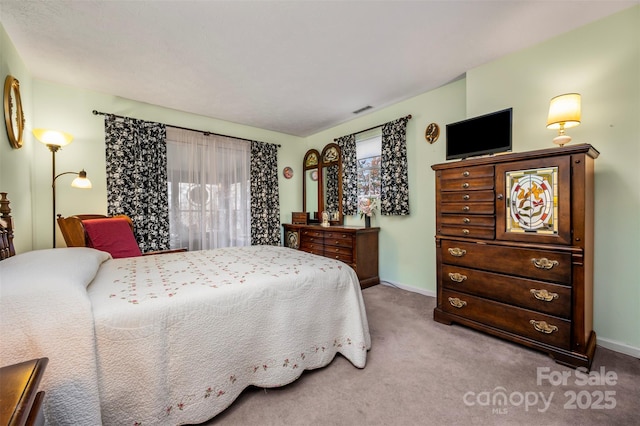 bedroom with carpet floors, visible vents, and baseboards