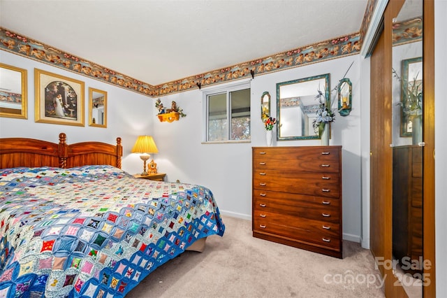 bedroom featuring baseboards and carpet flooring