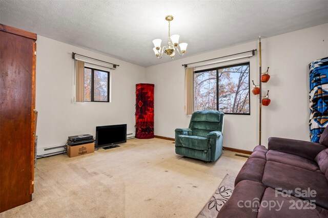 carpeted living area with baseboards, plenty of natural light, a chandelier, and a textured ceiling