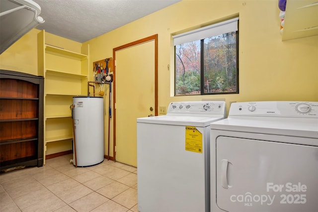 laundry room featuring light tile patterned floors, a textured ceiling, washing machine and dryer, laundry area, and water heater