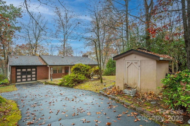 exterior space with an attached garage and aphalt driveway