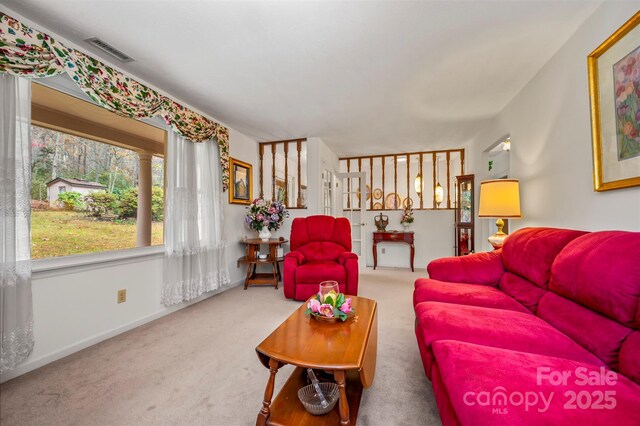 carpeted living room with visible vents and baseboards