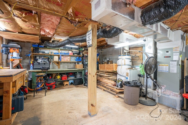 basement with a workshop area and heating unit